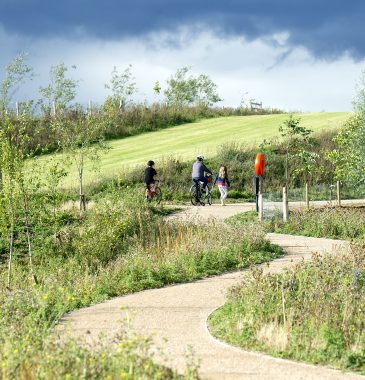 People cycling along a path in the countryside of Eddington